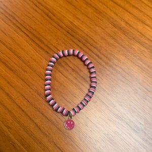 Clay bead bracelet with metal smiley face charm